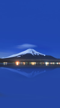Mount Fuji at night with reflection in the lake in winter