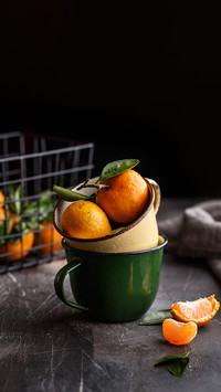 Ripe juicy clementines or tangerines with water drops