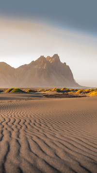 A scenic view of Vestrahorn mountain with dramatic
