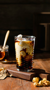 Iced coffee with cream on the table on a wooden board