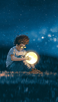 A man sitting on grass looking at a moon