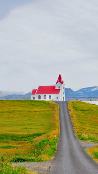 Lonely church in scenic landscape with road