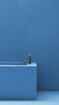 Bluetiled bathroom walls floor and top end of rectangular