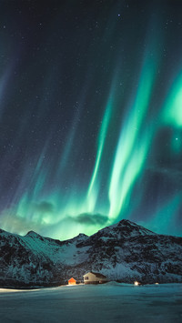 Northern Lights with Stars Glowing on Snowy Mountain