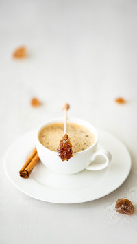 A cup of black coffee with cinnamon and caramelized sugar