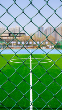 A bright and sunny urban community football field
