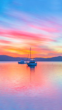 A colourful sunrise with boats