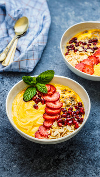 Smoothiebowl with mango passion fruit strawberries and