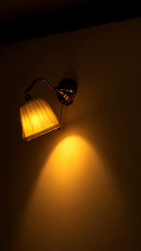 Lamp lit in living room illuminating wall