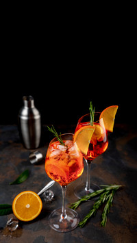 Ice cold Aperol spritz cocktail served in a wine glass