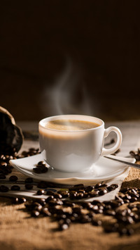 Warm cup of coffee on brown background