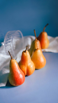 Juicy bright pears on a blue background