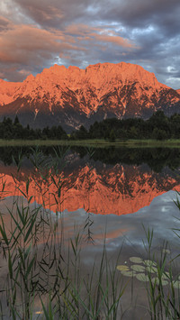 Mountains and clouds are reflected in the lake