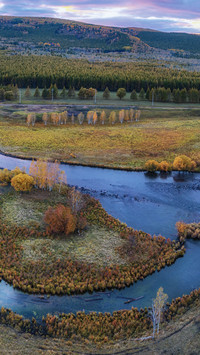 The colorful autumn scenery reflects over the mountains and