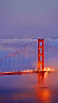 Fog covers the Golden Gate Bridge at sunset, CA-USA