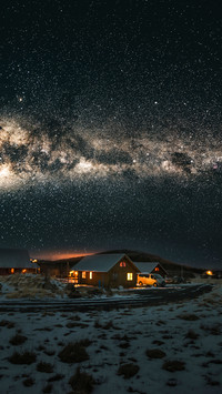 Village in iceland under the milky way galaxy