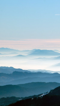 Clouds and mist surround the mountains