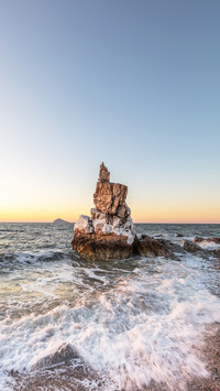 The rocks on beach that are hit by waves in the cold winter