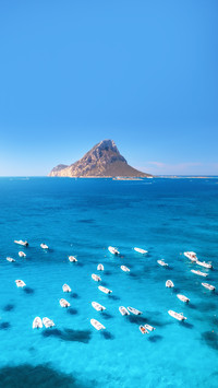 Aerial view of motorboats on blue sea at sunset in summer