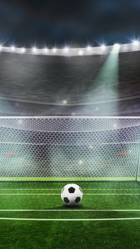 Ball on the green field at soccer stadium