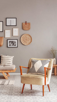 Trendy creme colored armchair in Scandinavian living room