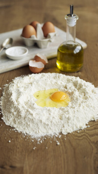 Egg olive oil and flour ready to be mixed together making