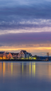 The morning light by the lake dyes the city walls
