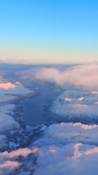Snowcapped mountains and misty clouds in the uninhabited
