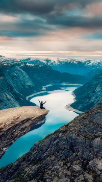 Woman Sitting on The Edge of A Cliff