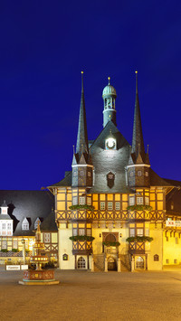 View over market square to illuminated town hall