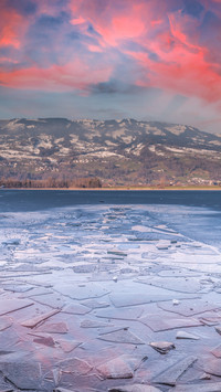 Breathtaking sunset over frozen lake like a painting.