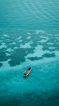A boat from above over a coral reef