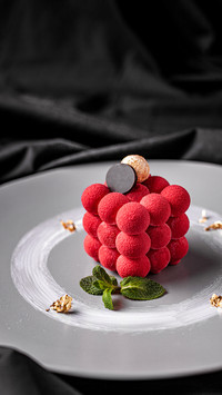 Red dessert with mango cream and edible gold