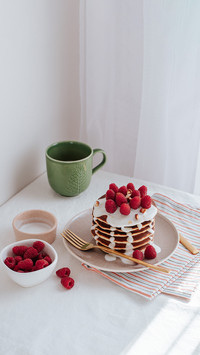 A stack of pancakes with vanilla sauce