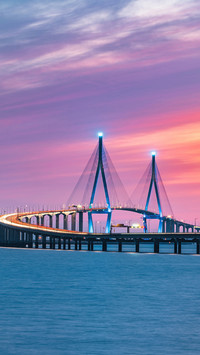 Curved Suspension Bridge, Lit Up in Blue at Dusk