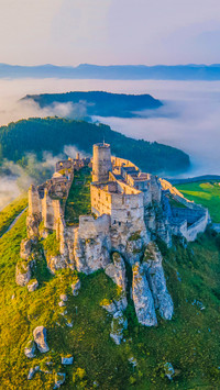 Castle in the morning sunlight with foggy background