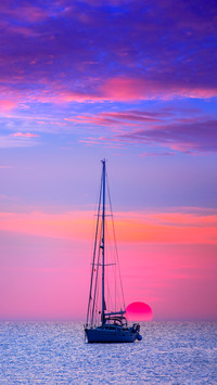 Ibiza sunset view from Formentera with sailboat
