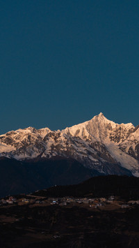 The morning light shines on the snowy peak