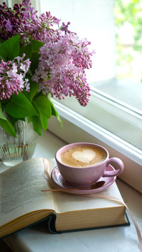 A cup of freshly brewed coffee with heart-shaped foam