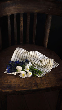 Bouquet of spring white and blue flowers in a vintage wooden