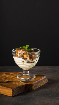 Traditional Italian dessert in glass on a wood plate