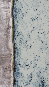 Aerial view of Iceland volcanic rock riverbank