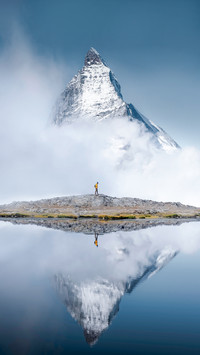 Hiker Man Walks Alone Through the Incredible Swiss Alps