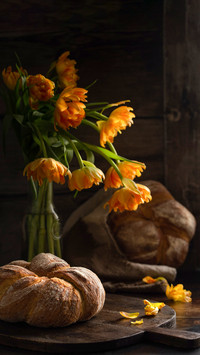 Round bread with tulips in the background