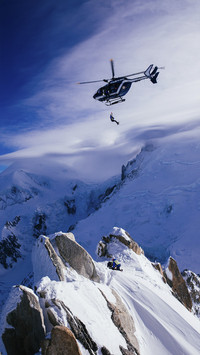Helocoper Fly over Snowy Mountain