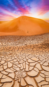 Desert Dune at sunset with cracked earth mud near Al Ain