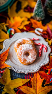 Christmas donuts on maple leaves on the desktop