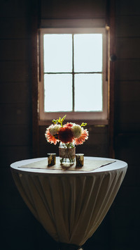 Bouquet of flowers in a vase on the table by the window