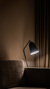 Lamp near the sofa at night. Modern living room at nighttime