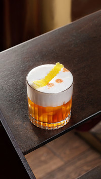 Old fashioned cocktail in a transparent whiskey glass